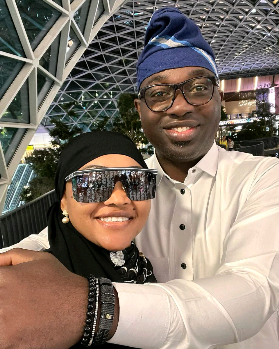 Alhaja Mercy Aigbe gets loved up with her husband as they return from Mecca